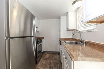 A kitchen with stainless steel appliances and a counter top